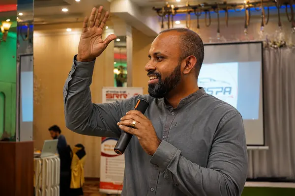On stage with a microphone at a MASPA session